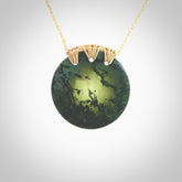 A lovely disc design with cupping on one side and the lightly convex form on the other - a little feature that captures the light and gives the piece a sense of movement and form. Hand made from New Zealand Jade by Ric Moor. Delivered with an adjustable beige cord.